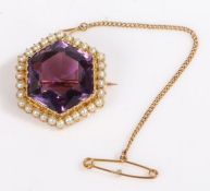 A 15ct yellow gold hexagonal cut amethyst and seed pearl brooch with a safety chain. Diameter 23.