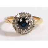 An 18ct gold sapphire and diamond cluster ring. Approx. carat weight of sapphire: 0.80cts. Total