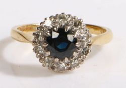 An 18ct gold sapphire and diamond cluster ring. Approx. carat weight of sapphire: 0.80cts. Total