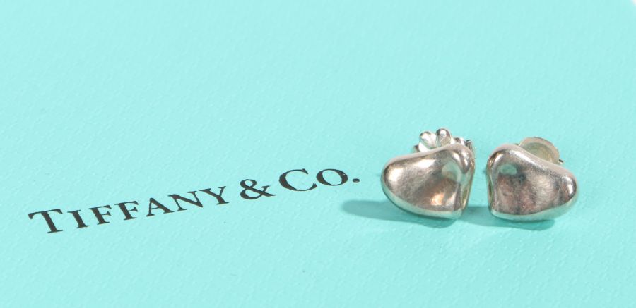 A pair of sterling silver Tiffany & Co. heart stud earrings. With original box. Diameter 9mm.