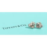 A pair of sterling silver Tiffany & Co. heart stud earrings. With original box. Diameter 9mm.
