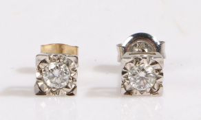 A pair of 9ct white gold diamond solitaire square stud earrings. Total approx. diamond carat