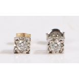 A pair of 9ct white gold diamond solitaire square stud earrings. Total approx. diamond carat