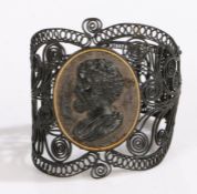 A Berlin ironwork bracelet with a steel backed cameo to the centre and filigree panels to either
