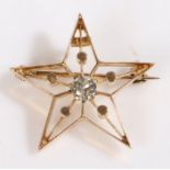 A 14ct yellow gold diamond set star brooch. Approx. diamond carat weight: 0.25cts. Colour: H.