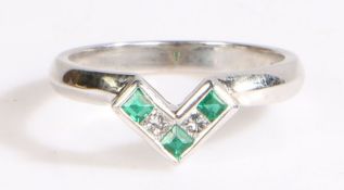 An 18ct white gold 'V' ring with emeralds and diamonds. Approx. total emerald carat weight: 0.21cts.