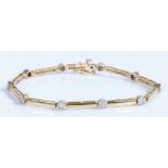 A 14ct yellow and white gold diamond set link bracelet. Approx. total diamond carat weight: 0.40cts.