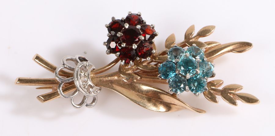 A 9ct yellow and white gold bunch of flowers brooch set with garnets and topaz and three small