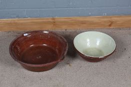 Two large 20th century dairy bowls both glazed, largest 51cm wide