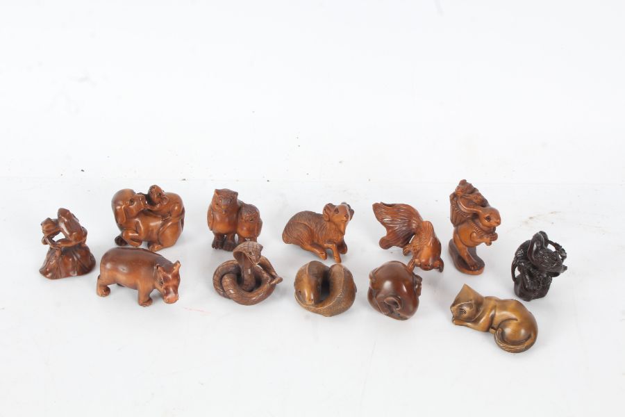 Twelve resin and wood netsukes, to include fish, ram, frogs, owls, rabbits, cat etc. (12)