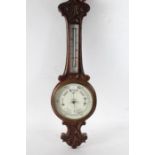 oak cased wheel barometer with shell decoration to the top together with a Smiths Arts and Crafts