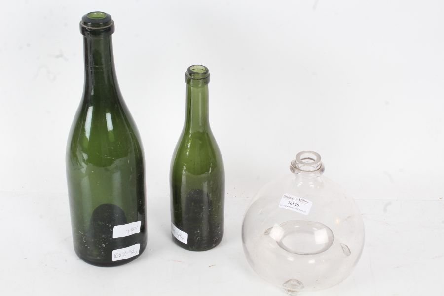 Victorian clear glass wasp catcher together with two early to mid 20th century green glass bottles