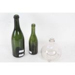 Victorian clear glass wasp catcher together with two early to mid 20th century green glass bottles