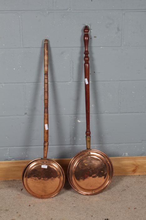 Two copper warming pans, one with floral decoration to the pan both with wooden handles (2)