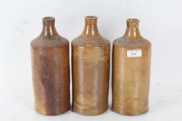 Three Victorian stoneware vessels all with a brown glaze, 26cm high