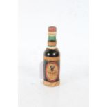 Miniature bottle of "Rhum Negrita" rum, the raffia wrapped bottle with oval label, 12.5cm high