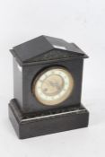 A black slate mantle clock with an arched pediment with a cream dial with Arabic numerals AF, 27cm