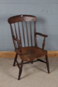 19th Century ash armchair, the arched bar back above turned spindles and a solid shaped seat with