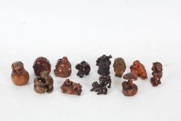 Twelve resin and wood netsukes, to include seated Buddha, figures, owl, bear, dogs, monkey etc. (