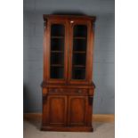 Victorian mahogany bookcase, with carved foliate decoration above two glazed doors and a cupboard