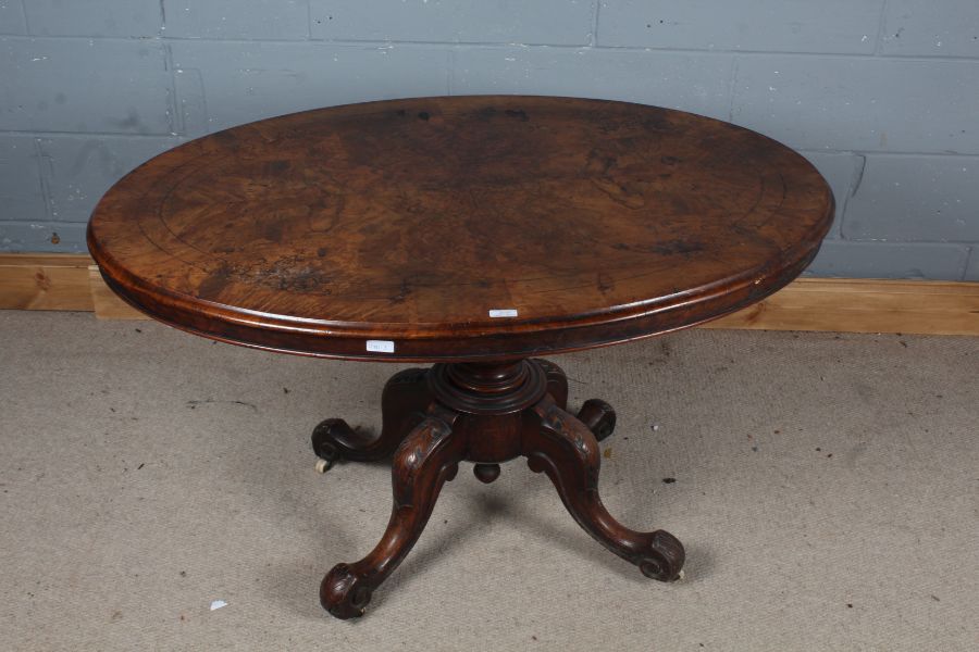 Victorian burr walnut loo table, the top with boxwood inlaid above a turned column and legs with