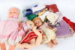 Collection of plastic dress dolls, with various clothing and small dolls in costume from around