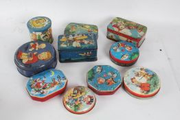 Collection of tins, mostly depicting children, a Christmas example, "The Nipper" by permission of