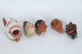 Four papier mache and plaster heads, and a carved wooden animal head painted in white (5)