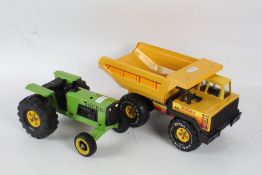 Two tin plate Tonka toys, the first in the form of a yellow tipper truck, 37cm long, the second in