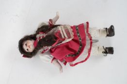 Modern bisque headed doll, on the form of a girl with platted hair, 37cm long