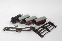 Hornby clockwork locomotive, in British Railways black livery, 82011, with three carriages and track