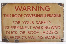 Enamel warning sign, 'This Roof Covering Is Fragile', in red lettering, 31.5cm wide, 20cm high