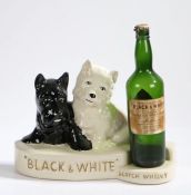 Crown Devon advertising stand for 'Black & White Scotch Whisky', modelled as a black and a white dog