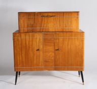 Mid 20th century cocktail cabinet, the drop front enclosing a sliding mirrored tray, with a pair