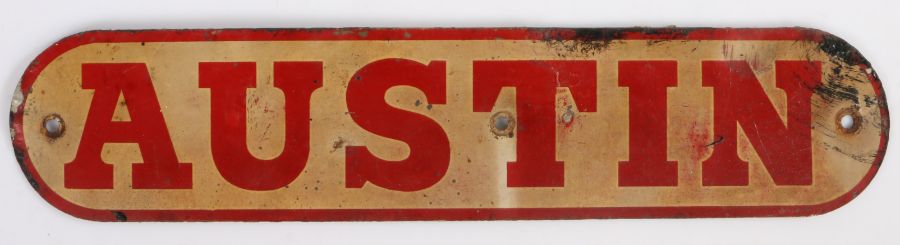 Austin metal advertising plaque, in red lettering on white ground, with rounded ends, 35cm long