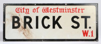 Enamel street sign, for City of Westminster, Brick St. W.1., in red and black lettering on white