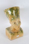 Egyptian revival pottery bust, with green glaze on a yellow ground, 41cm tall