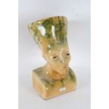 Egyptian revival pottery bust, with green glaze on a yellow ground, 41cm tall