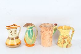 Four various pottery jugs, all in the Art Deco taste, to include a Weatherby example with Woodpecker