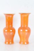 Near pair of Carlton Ware orange lustre vases, with slender necks and baluster bodies, 28cm tall (