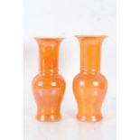 Near pair of Carlton Ware orange lustre vases, with slender necks and baluster bodies, 28cm tall (