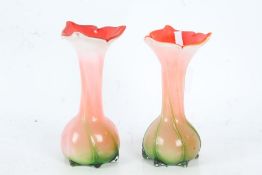 Pair of art glass vases, having bright orange interiors with bulbous bodies and green stem