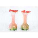 Pair of art glass vases, having bright orange interiors with bulbous bodies and green stem