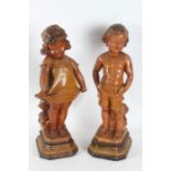 Pair of Art Deco plaster figures, in the form of a girl and boy, the boy with registration number to