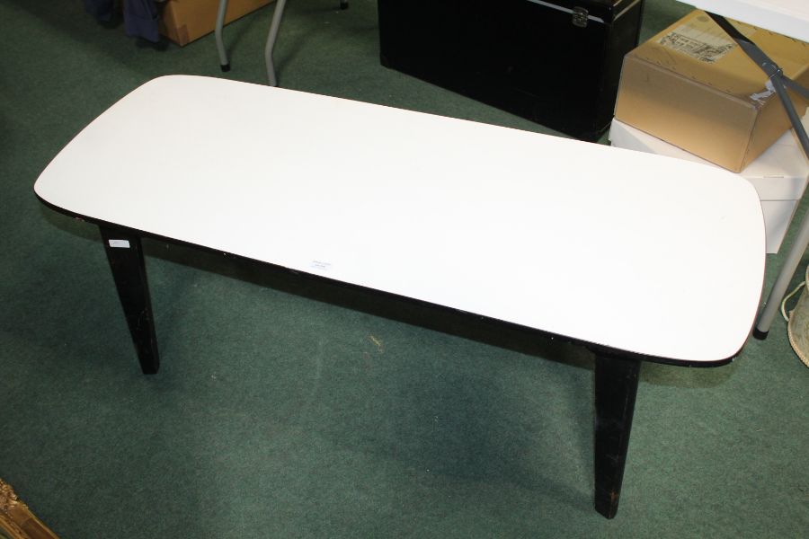 1960's style black and white coffee table, raised on tapering legs, 123cm long, 47cm high