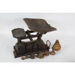 Set of cast iron scales, with a set of six graduating weights to the base, and a collection of