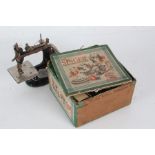 Miniature Singer sewing machine, housed in original box, with manual