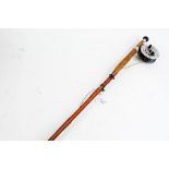 Two piece cane fishing rod with reel, (makers label missing)