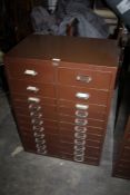 Brown metal double filing cabinet, with two banks of twelve drawers, 61cm wide, 84.5cm high, 41cm