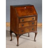 20th century mahogany veneered bureau, with a sloping fall above three draws raised on cabriole